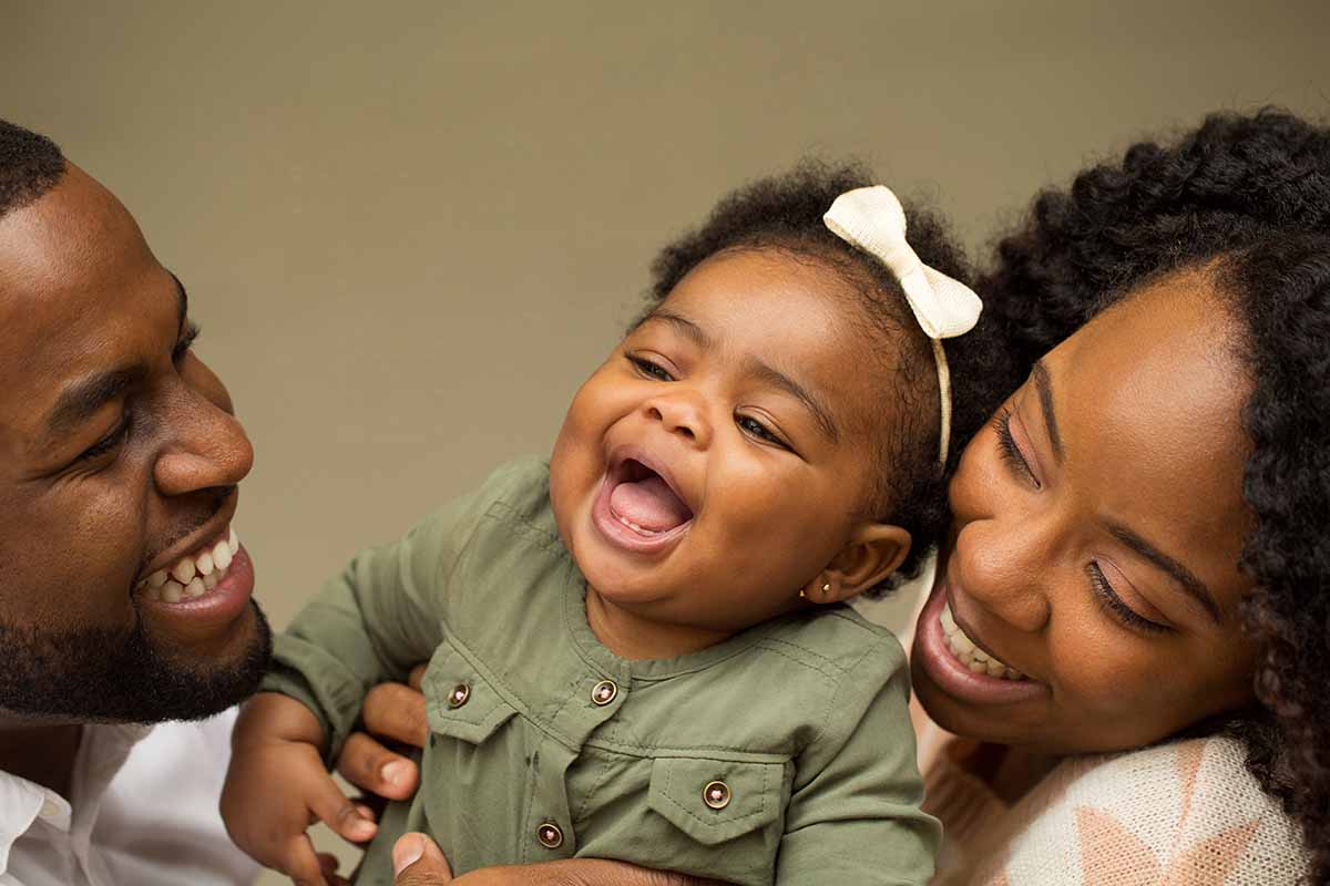 Laughing family of three